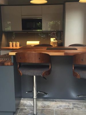 Walnut chairs and worktop. Modern kitchen from DIY Kitchens